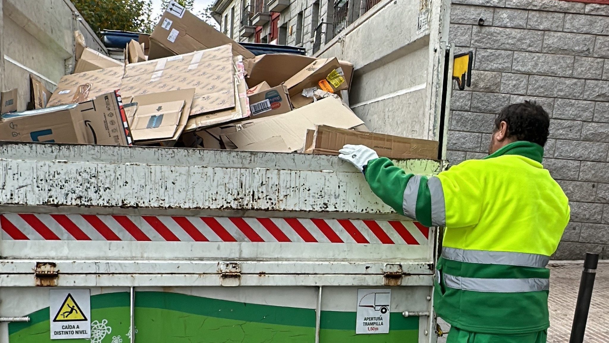 Los operarios de limpieza recogen el cartón de los comercios tres días a la semana