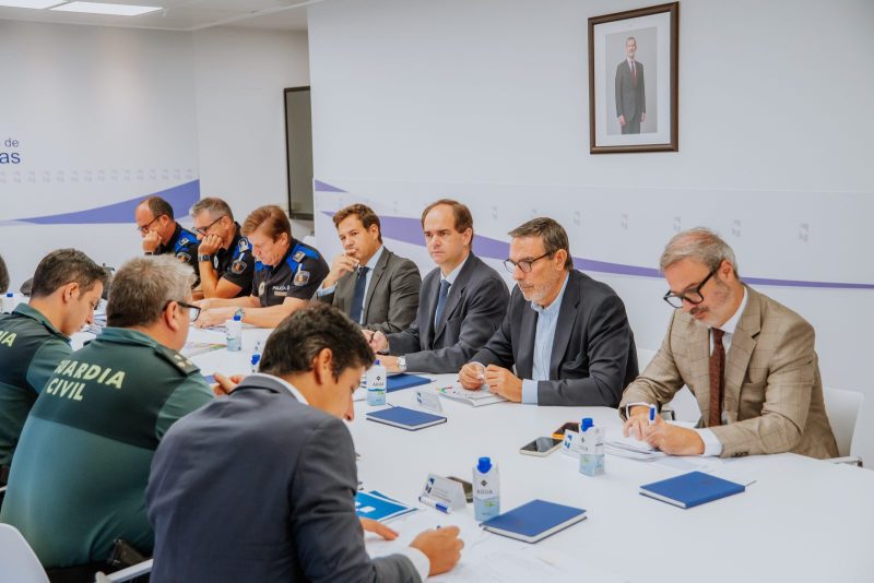Autoridades locales y mandos policiales reunidos alrededor de una mesa de juntas.