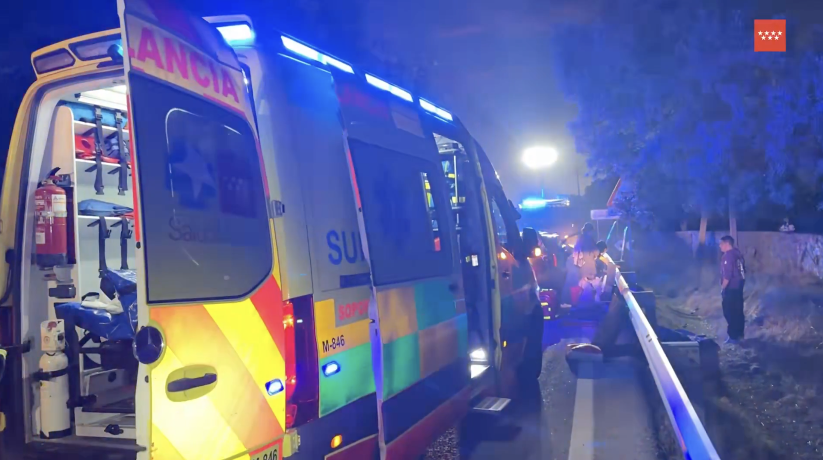 Ambulancia del SUMMA 112 con las luces de emergencia encendidas en la carretera de noche.