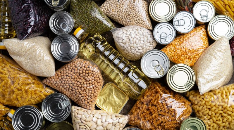 Donations food with canned food on the table background. Donate concept. Close up.
