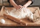 Close-up of unrecognizable woman touching hill of flour while kneading dough with hands