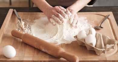 Close-up of unrecognizable woman touching hill of flour while kneading dough with hands