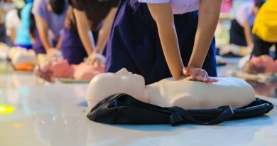A person performs CPR chest compressions on a during a training session, highlighting essential life-saving techniques and emergency preparedness.