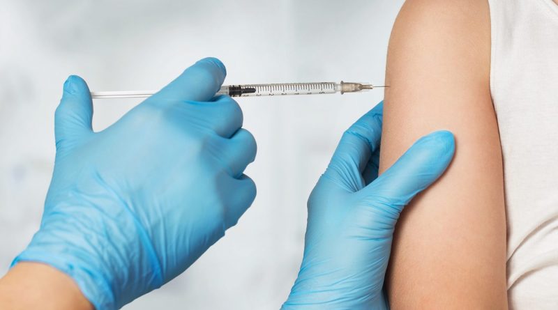 Close up of doctor's hands vaccinating child